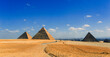 Giza, Cairo / Egypt: Long view of the Pyramids of Giza with Cairo in the distance