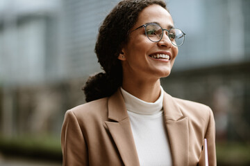 Happy businesswoman walking outdoors