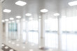 © Aleksei - Blurred defocused bokeh background of exhibition hall or convention center hallway. Business trade show modern white interior architecture. Abstract blur modern business office background