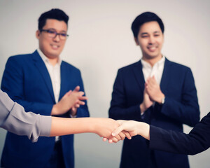 Wall Mural - Business people shaking hands, between meeting in seminar room