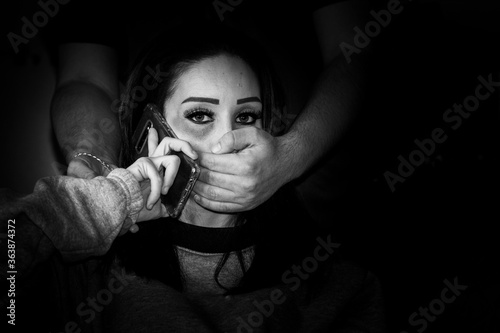 Midsection Of Man Covering Woman Mouth With Hands