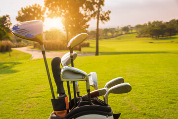 Wall Mural - The Golf club bag for golfer training and play in game with golf course background , green tree sun rays