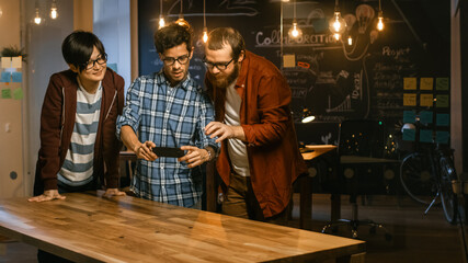 Poster - Great Concept For Augmented Reality Mock-up. Three Young Developers Look at Augmented Reality Through Smarthpone. They're Working on the New Virtual Reality Game.