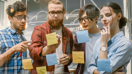 Poster - Diverse Team of Young Developers Brainstorming, They Have Discussion and Use Glass Board and Sticky Papers to Conceptualize Their New Plan. Creative People in Stylish Office Environment.