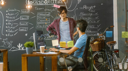 Poster - Two Young Developer Work on a Personal Computer, Talking. In the Background Modern Stylish Loft Office.