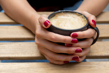 Hand holding coffee cup, selective focus