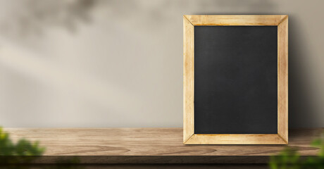 Leinwandbilder - blackboard on wood table background with sunlight window and leaf shadow on wall with blur indoor green plant.panoramic banner mockup for display of product,3d rendering
