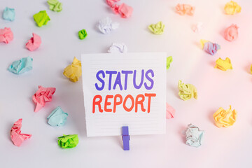 Poster - Word writing text Status Report. Business photo showcasing summarizes the particular situation as of a stated period Colored crumpled papers empty reminder white floor background clothespin