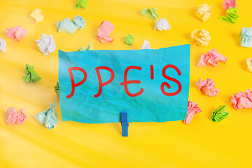 Poster - Conceptual hand writing showing Ppe s is. Concept meaning Specialized equipment for protection against health and safety hazard Colored crumpled paper empty reminder white floor clothespin