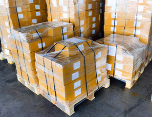 shipment cartons box on pallets and wooden case on hand lift in interior warehouse cargo for export 