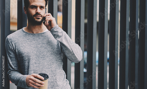 Cuadros en Lienzo Confident male entrepreneur having phone conversation in roaming with administra