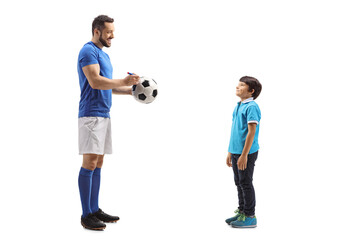 Poster - Footballer signing an autograph on a soccer ball for a boy fan