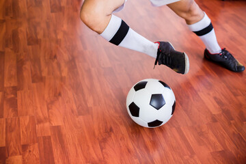 Sticker - Selective focus to ball with futsal player run to shoot ball to goal on wooden floor in sport hall. Indoor soccer sports hall. 