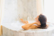 © siraphol - Portrait beautiful young asian woman relax take a bath