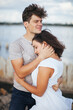 © vadik02020 - Beautiful people in love. The woman put her head on the man's shoulder.A married couple is relaxing at the sea. A woman in a white dress on the beach. Husband and wife walking along the beach. Love. R
