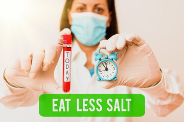 Wall Mural - Text sign showing Eat Less Salt. Business photo showcasing reducing the sodium intake on the food and beverages Laboratory blood test sample shown for medical diagnostic analysis result