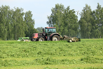 Wall Mural - tractor mows green grass