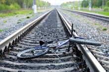 Accident With A Bicycle In Railway Road. Broken Bicycle Lying Between Railroad Rails.