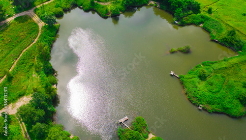 Cuadros en Lienzo Aerial view of natural pond surrounded by pine trees