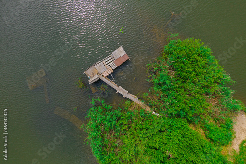 Fotografía Aerial view of natural pond surrounded by pine trees