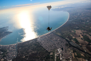 Two men enjoys sky diving.