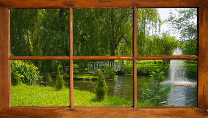  View of a beautiful pond in the summer, looking out of the window.