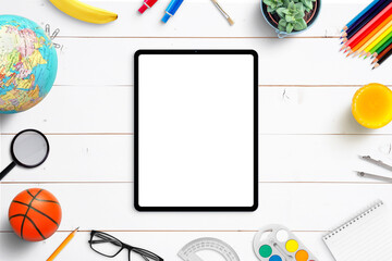 Poster - Tablet mockup on white wooden desk surrounded by school supplies, snack and toys