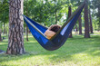 © Hennadii - Young guy has a rest in summer in a hammock