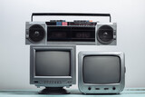 Fototapeta  - Two old tv receiver with audio tape recorder on a white wall background. Retro media