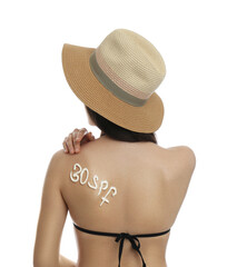 Wall Mural - Text 30 SPF written with sun protection cream on woman's back against white background