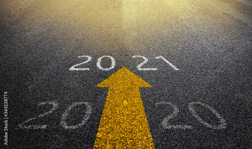 New Year 2021 Concept : Empty asphalt street road and writing text 2020 and 2021 on roadway.