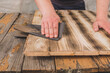sandpaper wood treatment/type of male hands processing sandpaper wood