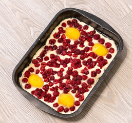 Raw raspberries and apricots pie on a oven-tray