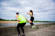 © Georgii - Athletic guy and girl fitness trainers train and jump on the street. Healthy sport lifestyle. Photography for ad or blog