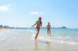 © madhourse - Two girlfriends run along the coastal strip of the sea coast