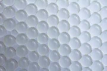 Macro of white gel balls. Abstract clean light geometric hydrogel background