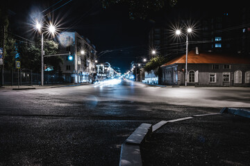 view of the evening and night streets of the city with cars people and beautiful buildings