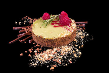 Tasty raspberry tart with white chocolate with reflection, isolated on black background