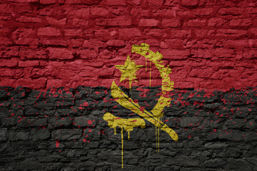 Wall Mural - painted big national flag of angola on a massive old brick wall