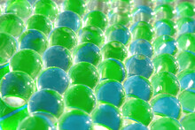 Macro Of Fresh Light Green Colour And Blue Gel Balls. Abstract Bright Geometric Background