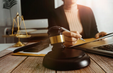 Business and lawyers discussing contract papers with brass scale on desk in office. Law, legal services, advice, justice and law concept