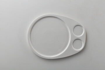 Wall Mural - Top view shot of a rectangular white plate on white background.