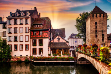 Canvas Print - Beautiful view of Strasbourg France at sunset with half timbered architecture and canal in view