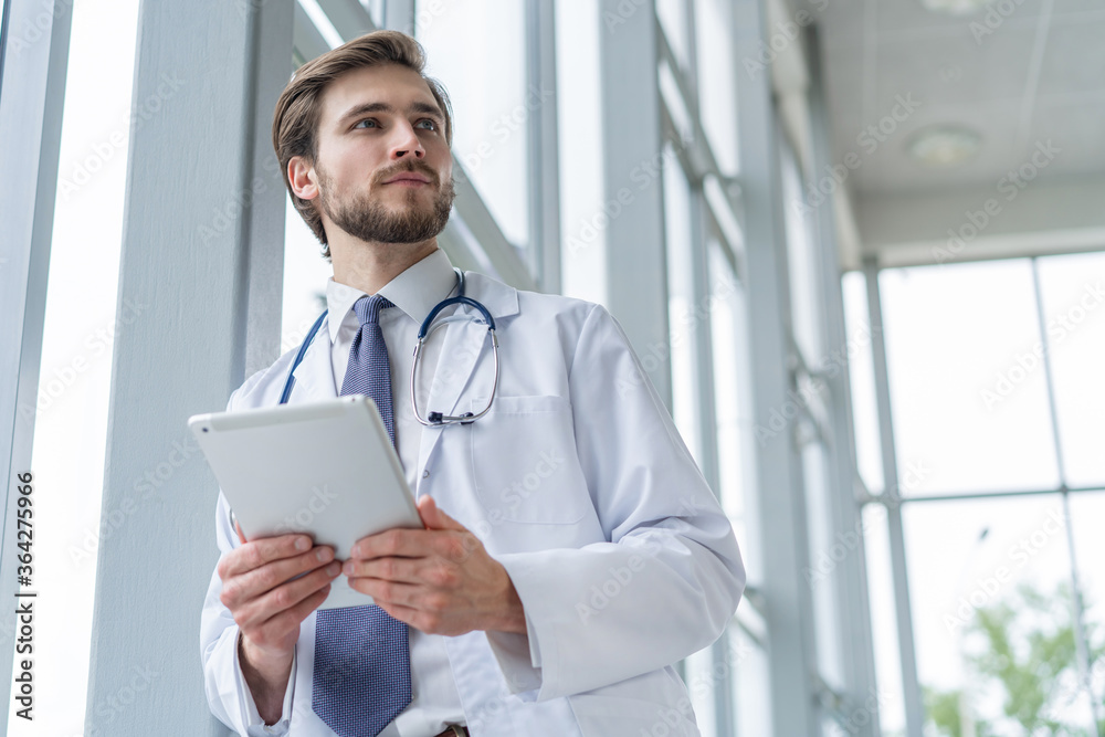 male medical doctor using tablet computer in hospital. Stock Photo ...