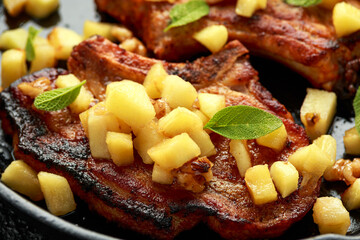 Wall Mural - Roasted Pork chops with caramelized apples, walnuts and sage in a cast iron pan