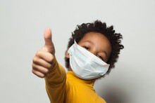 Happy African American Black Kid In Medical Protective Face Mask Showing Thumb Up On White