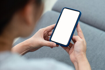 asian woman wearing causual outfit siiting on the couch and using smartphone at home. technology concept