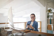 © Seventyfour - Portrait of modern young woman wearing glasses and smiling at camera while sitting at workplace in white office, female IT developer concept, copy space