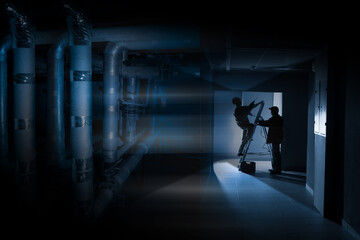 Poster - repair work in the room. workers in a dark technical room. installation of the lighting system. fini