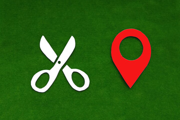 Fototapete - Scissors are white, and the geolocation sign is red on a green background.  Place of Atelier, tailoring and repair of clothing.